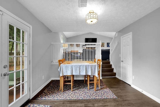 5461 Forest Path Ct, Stone Mountain, GA 30088 - dining room with wood finished floors, baseboards, a textured ceiling, lofted ceiling, and stairs