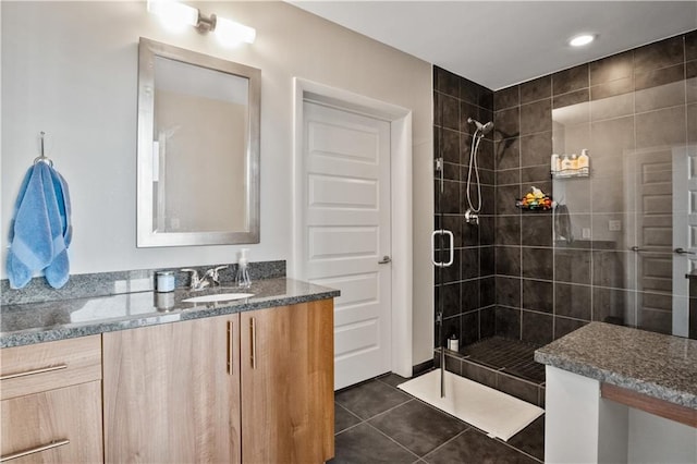 full bath with a stall shower, vanity, and tile patterned floors