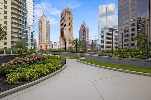 view of property's community with a view of city and fence