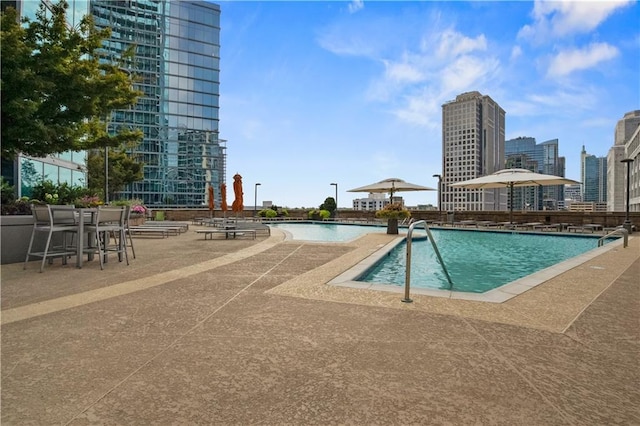 community pool featuring a city view and a patio