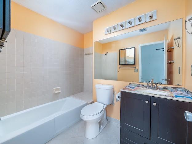 904 Bridge Ln SE, Smyrna, GA 30082 - bathroom with tile patterned flooring, toilet, vanity, and bathing tub / shower combination