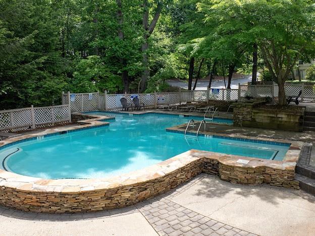 904 Bridge Ln SE, Smyrna, GA 30082 - community pool featuring fence, a patio area, and a jacuzzi