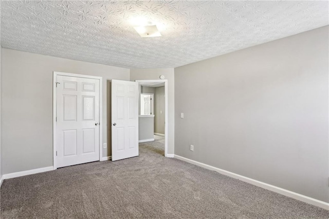 unfurnished bedroom with a closet, a textured ceiling, and carpet flooring