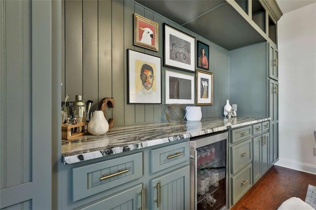 bar with wine cooler, baseboards, and dark wood finished floors