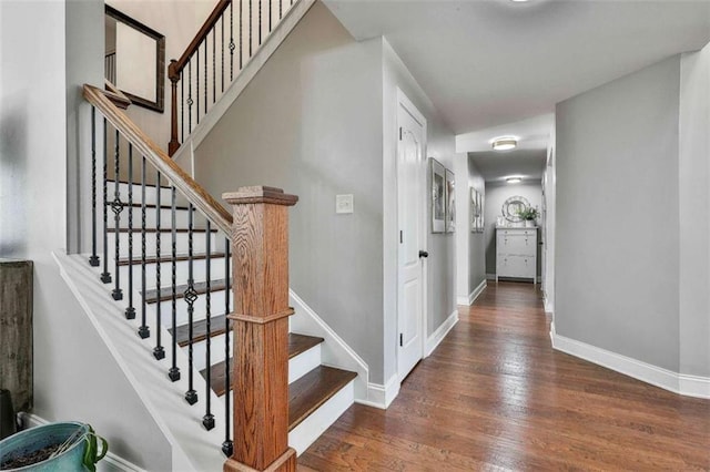 stairs with baseboards and wood finished floors