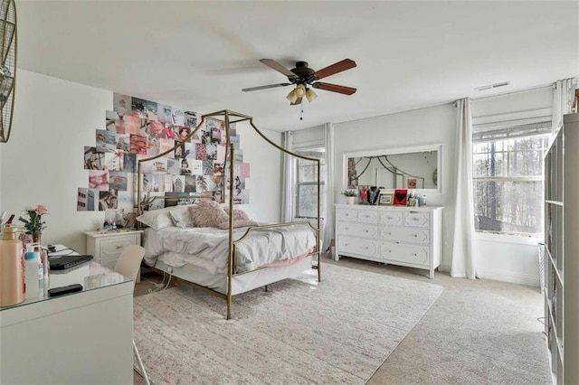 bedroom featuring ceiling fan and carpet