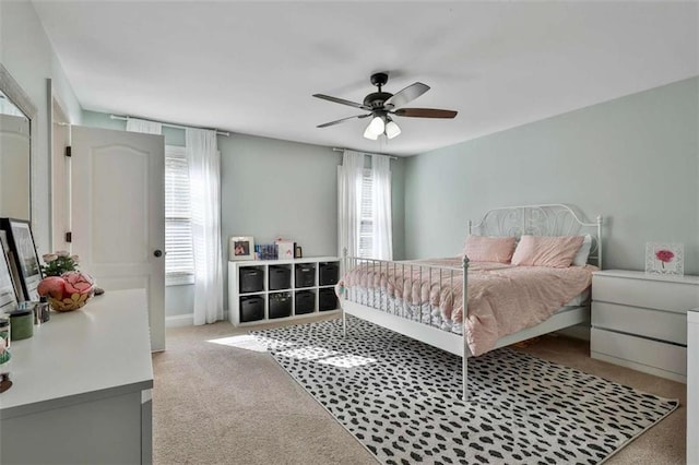 bedroom featuring a ceiling fan, baseboards, and carpet