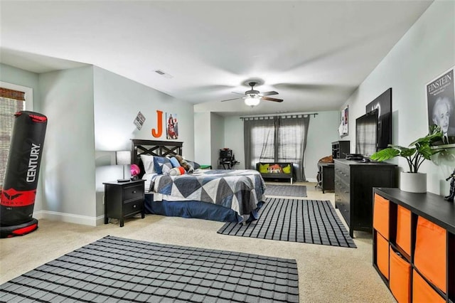 bedroom with baseboards, visible vents, light colored carpet, and ceiling fan
