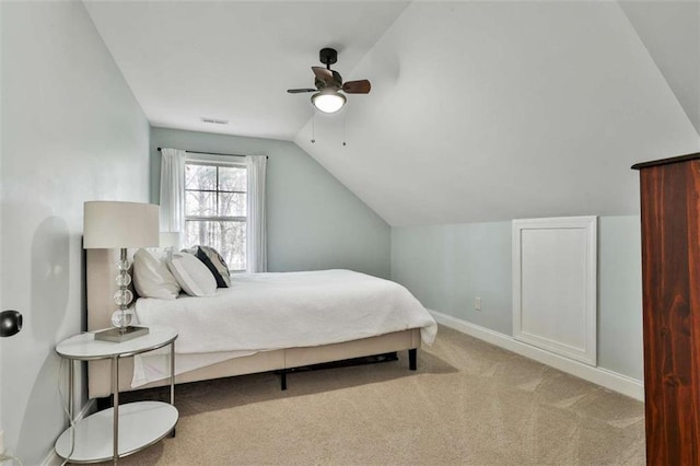 bedroom with carpet flooring, baseboards, visible vents, lofted ceiling, and a ceiling fan