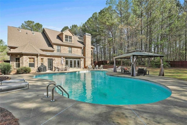 outdoor pool featuring french doors, a grill, a gazebo, fence, and a patio area