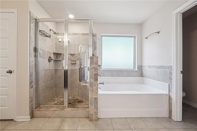bathroom with toilet, tile patterned flooring, a garden tub, and a stall shower