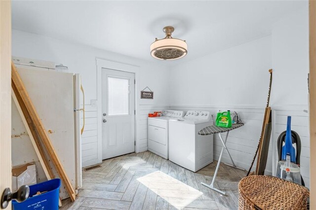 laundry room featuring visible vents, wainscoting, laundry area, and washer and clothes dryer