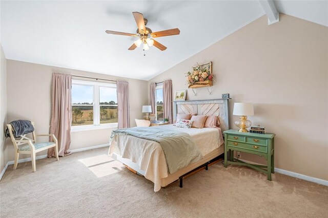 bedroom featuring light colored carpet, vaulted ceiling with beams, baseboards, and ceiling fan