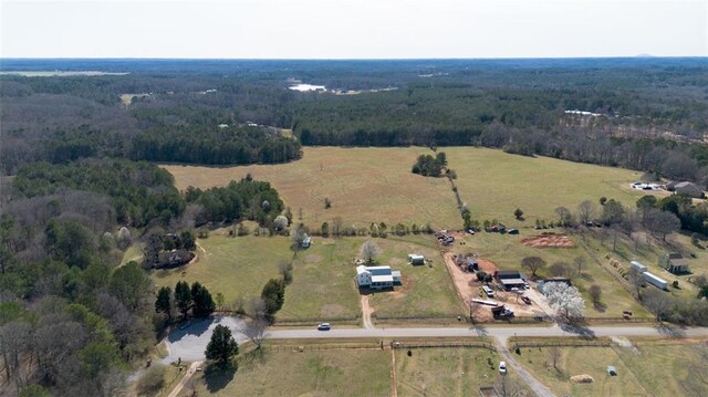 aerial view featuring a view of trees and a rural view