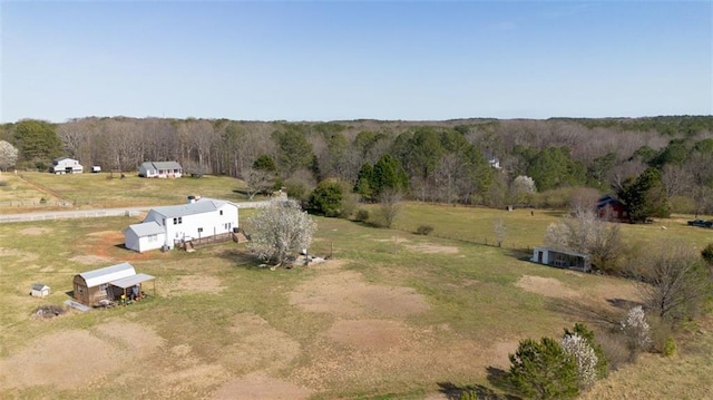 birds eye view of property with a forest view and a rural view