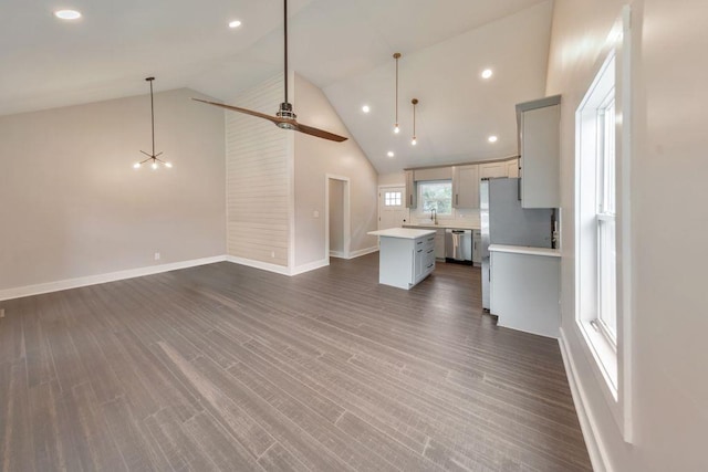 interior space with high vaulted ceiling, sink, ceiling fan, and dark hardwood / wood-style floors