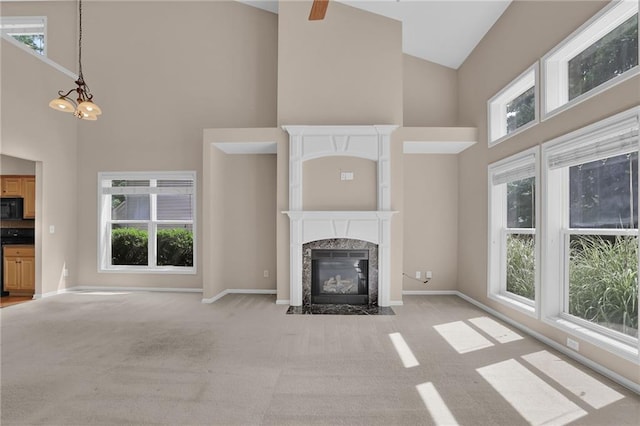 5040 Stonehaven Vw, Cumming, GA 30040 - unfurnished living room featuring high vaulted ceiling, light carpet, a fireplace, plenty of natural light, and baseboards