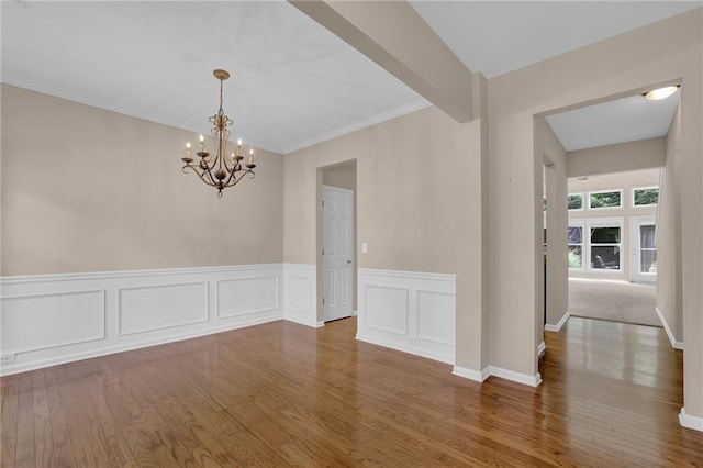 5040 Stonehaven Vw, Cumming, GA 30040 - unfurnished dining area featuring a chandelier, wood finished floors, a wainscoted wall, and crown molding