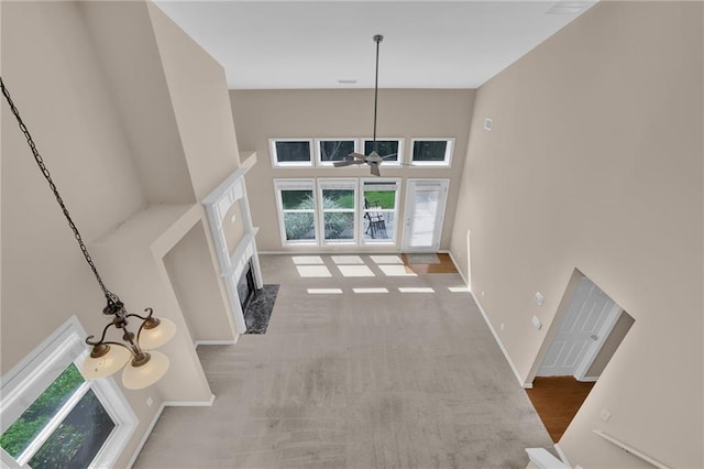 5040 Stonehaven Vw, Cumming, GA 30040 - unfurnished living room with plenty of natural light, a high ceiling, a fireplace, ceiling fan, and baseboards