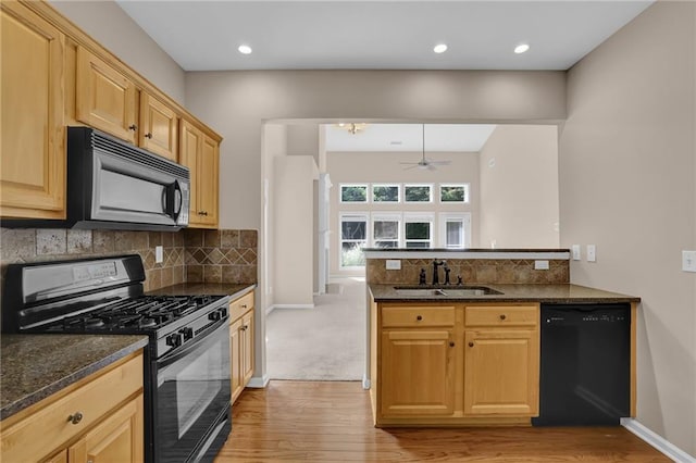 5040 Stonehaven Vw, Cumming, GA 30040 - kitchen featuring black appliances, a sink, light wood finished floors, a peninsula, and baseboards