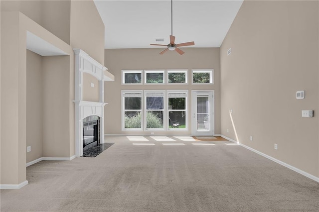 5040 Stonehaven Vw, Cumming, GA 30040 - unfurnished living room with ceiling fan, carpet floors, a high ceiling, a fireplace, and baseboards
