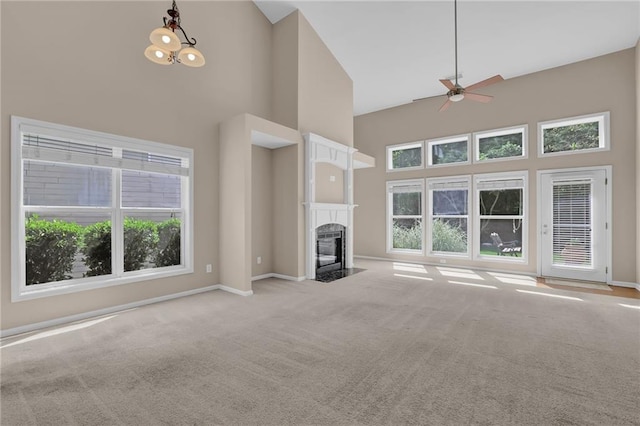 5040 Stonehaven Vw, Cumming, GA 30040 - unfurnished living room featuring high vaulted ceiling, plenty of natural light, carpet flooring, ceiling fan, and a fireplace with flush hearth