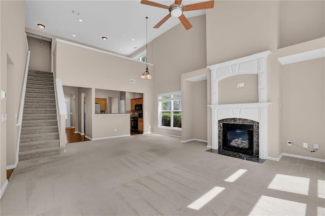 5040 Stonehaven Vw, Cumming, GA 30040 - unfurnished living room with high vaulted ceiling, carpet floors, a ceiling fan, a fireplace, and baseboards
