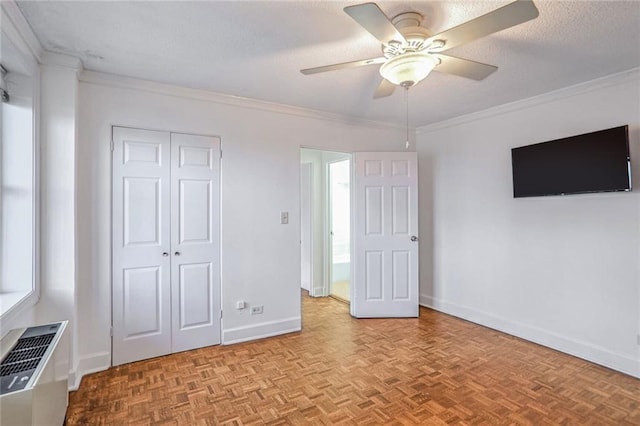 unfurnished bedroom featuring ornamental molding, light parquet flooring, and ceiling fan