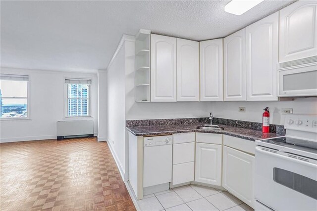 kitchen with white cabinetry, a textured ceiling, sink, and white appliances