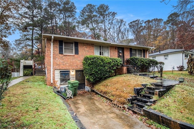 view of front of property with brick siding and a front yard