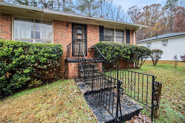 view of front of house with brick siding and a front lawn