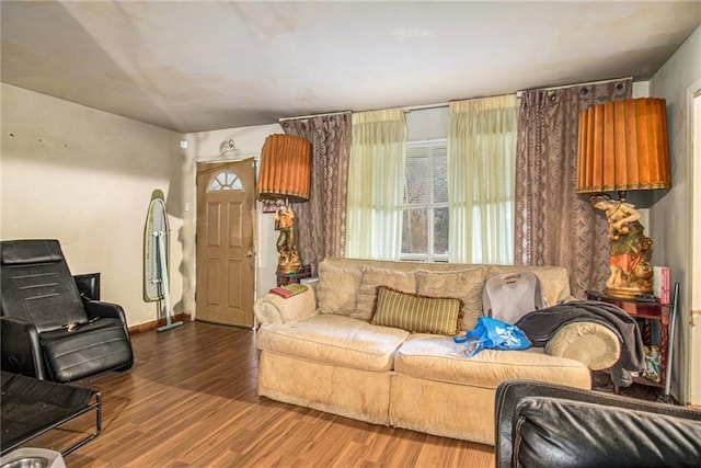 living area with baseboards and wood finished floors