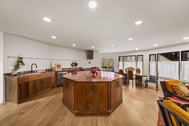 595 Overbrook Dr NW, Atlanta, GA 30318 - kitchen with a sink, dishwasher, dark stone countertops, a kitchen island, and light wood finished floors