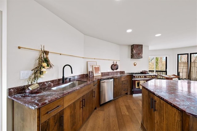 595 Overbrook Dr NW, Atlanta, GA 30318 - kitchen with a sink, appliances with stainless steel finishes, wood finished floors, dark stone counters, and recessed lighting