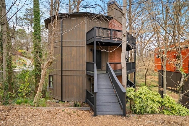 595 Overbrook Dr NW, Atlanta, GA 30318 - rear view of house with stairs, a chimney, and a balcony