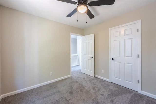 unfurnished bedroom featuring carpet flooring, ceiling fan, and baseboards