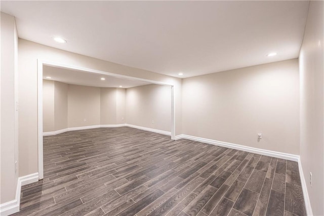 finished basement featuring dark wood-style floors, recessed lighting, and baseboards