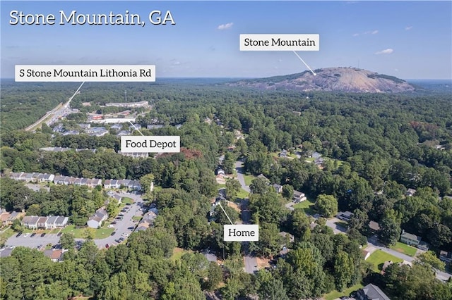 aerial view featuring a forest view and a mountain view