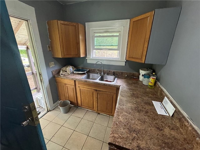 kitchen with brown cabinetry, a sink, and plenty of natural light