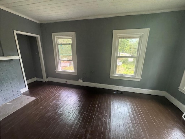 unfurnished room featuring baseboards, ornamental molding, and hardwood / wood-style flooring