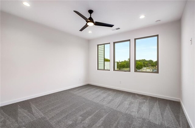 spare room featuring carpet floors and ceiling fan