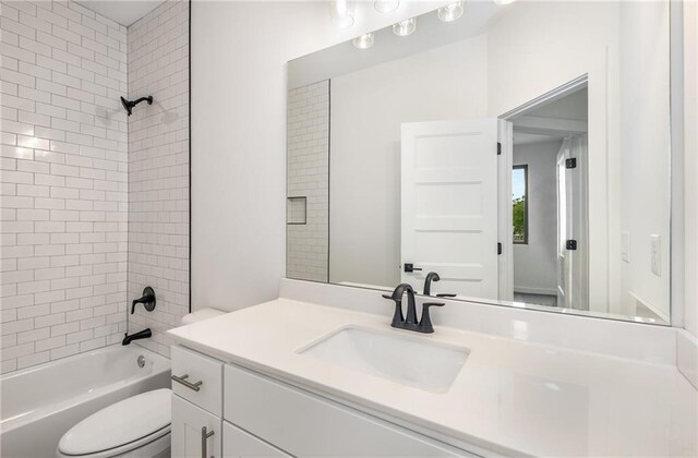 full bathroom with vanity, toilet, and tiled shower / bath combo