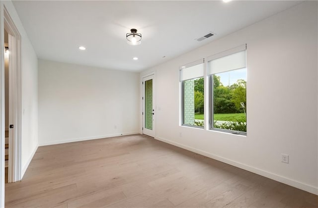 spare room featuring light hardwood / wood-style floors