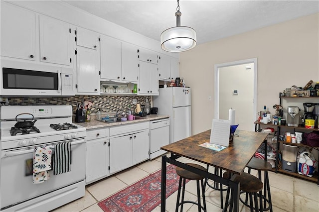 kitchen with sink, white cabinetry, white appliances, and decorative backsplash