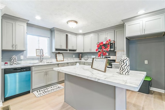 kitchen featuring gray cabinetry, sink, light hardwood / wood-style flooring, stainless steel dishwasher, and light stone countertops