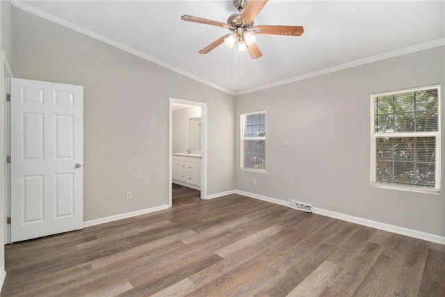 unfurnished bedroom with crown molding, ceiling fan, dark wood-type flooring, and ensuite bathroom