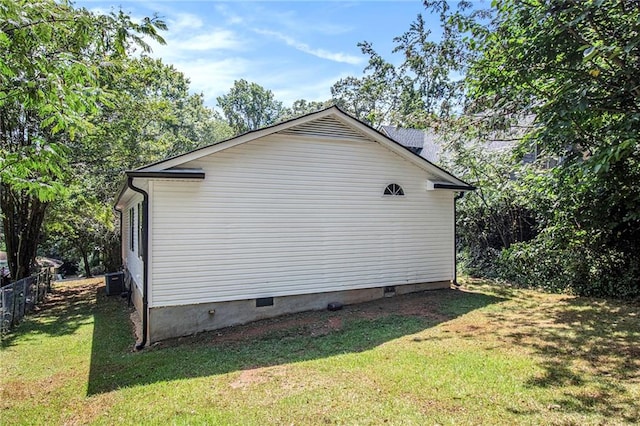 view of side of property with a yard and central AC unit