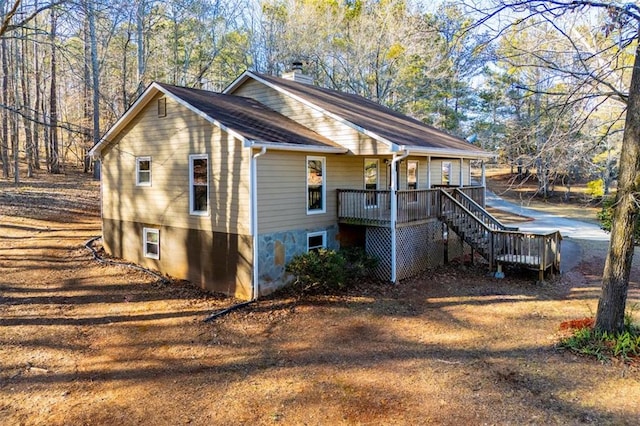 view of side of property with a wooden deck