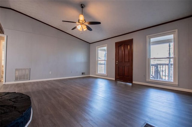 interior space with lofted ceiling, dark hardwood / wood-style flooring, ornamental molding, and ceiling fan