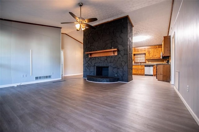 unfurnished living room featuring a fireplace, wood-type flooring, vaulted ceiling, and ceiling fan